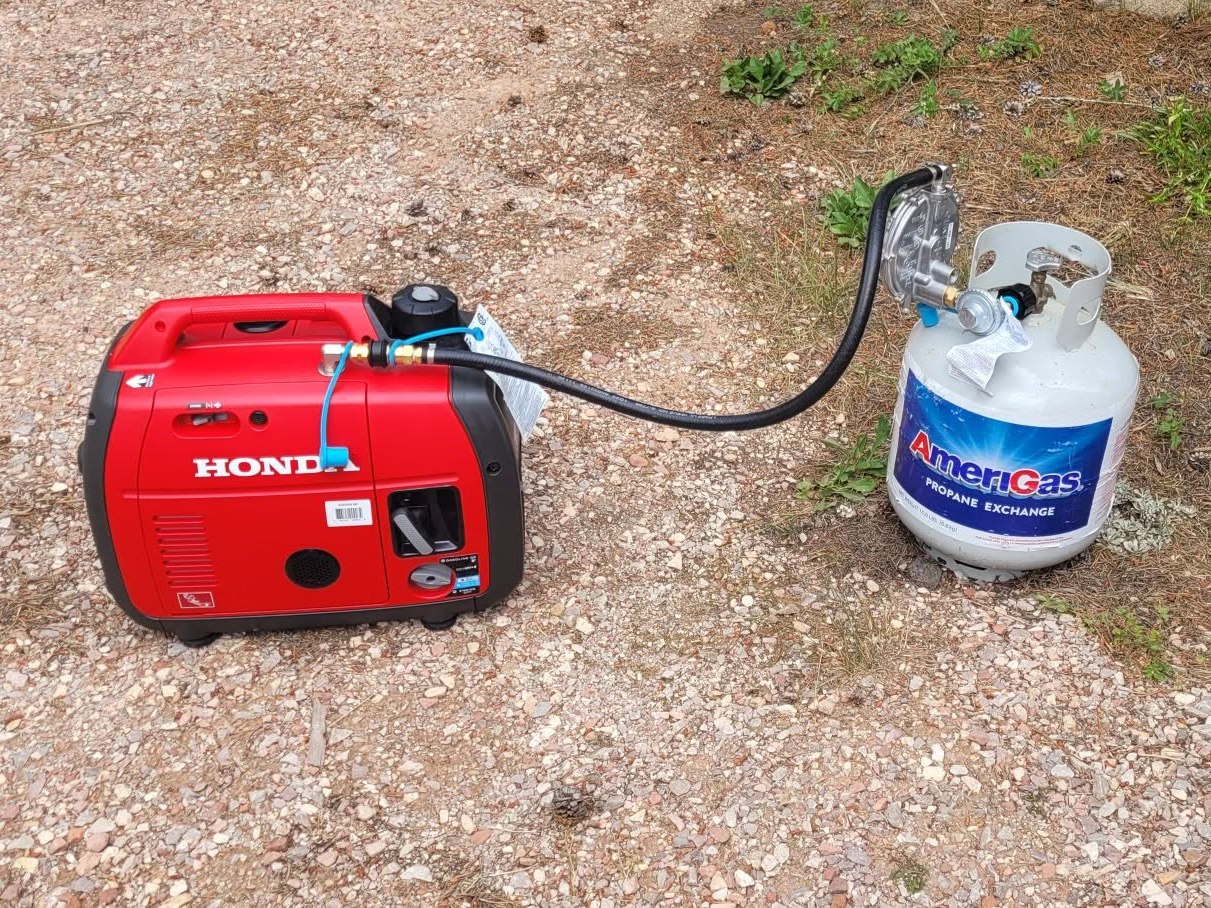 Portable generator running on a gas cylinder through a conversion regulator